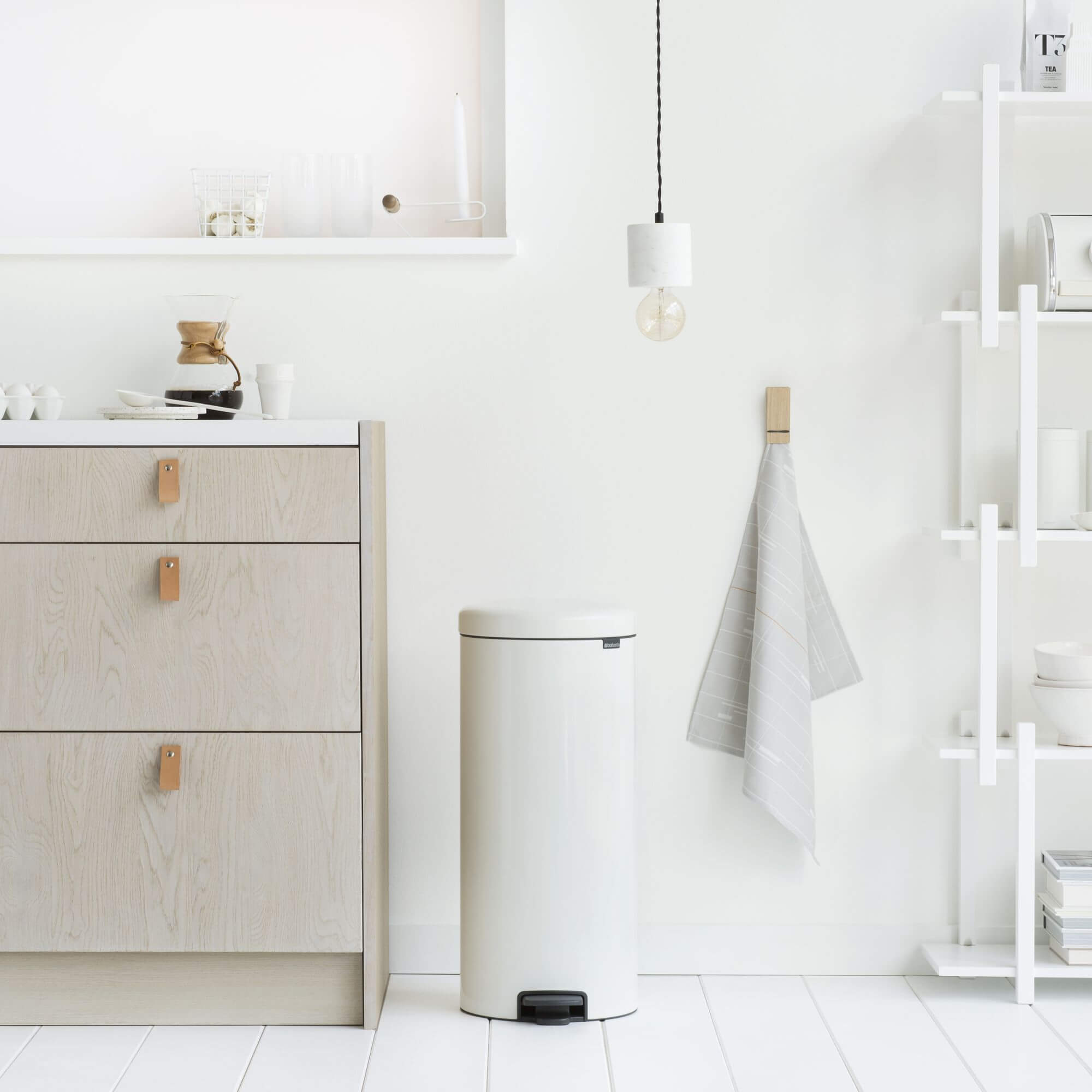 A white Brabantia kitchen bin in a European style home