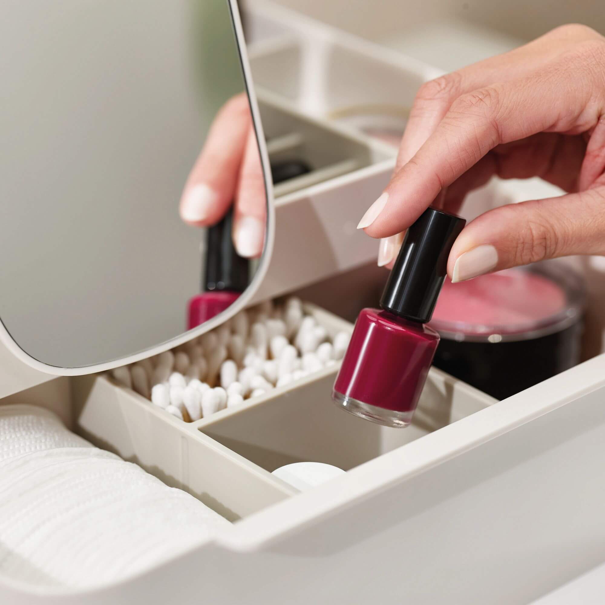 A Joseph Joseph makeup organiser holding nail polish, blush and accessories