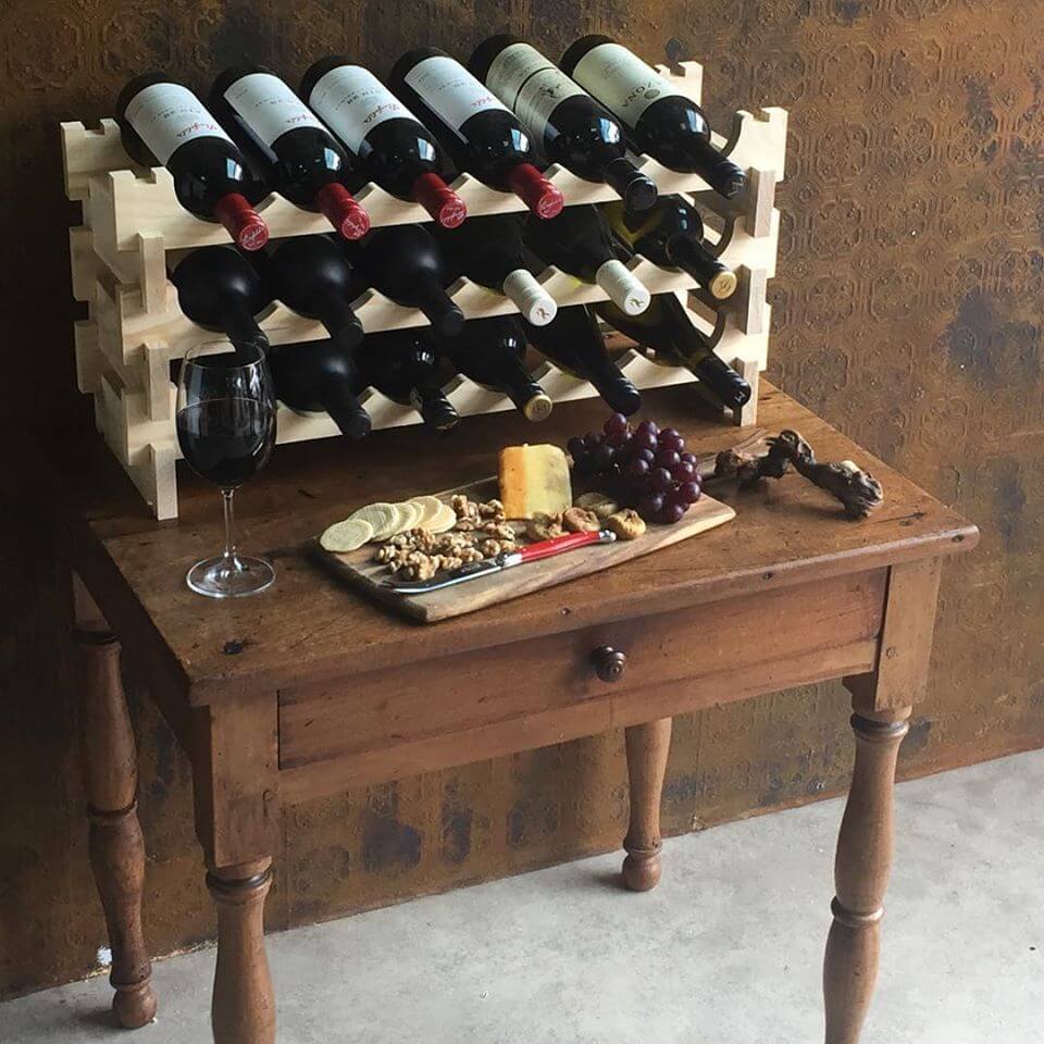 Natural timber wine rack storing 18 bottles of wine on a wooden table