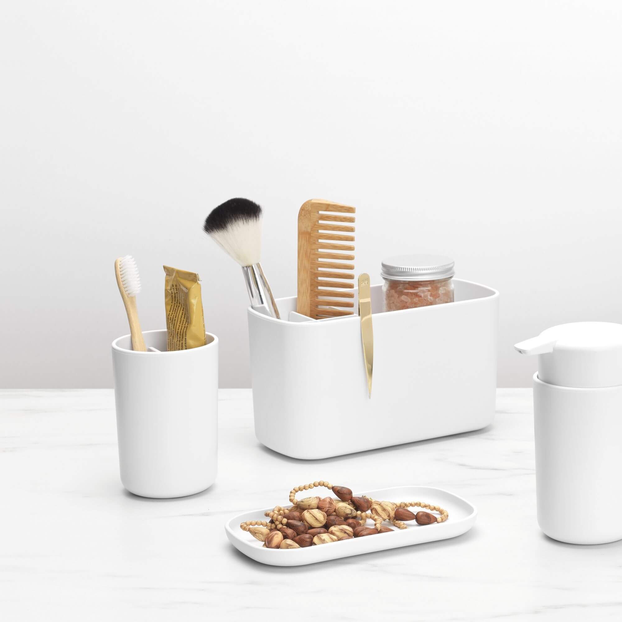 A white Brabantia toothbrush holder and tumbler on a marble benchtop
