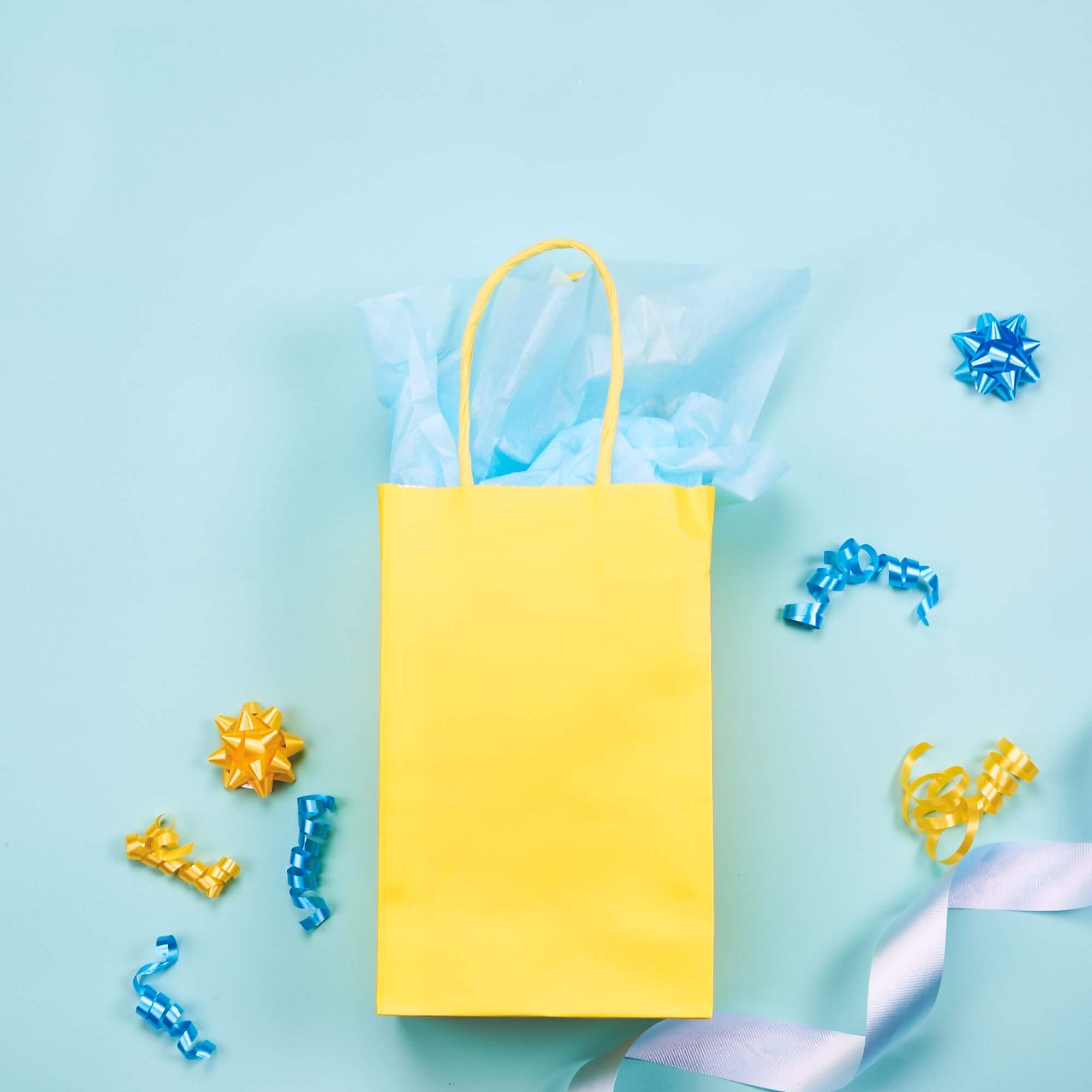 Yellow gift bag with ribbon and bows
