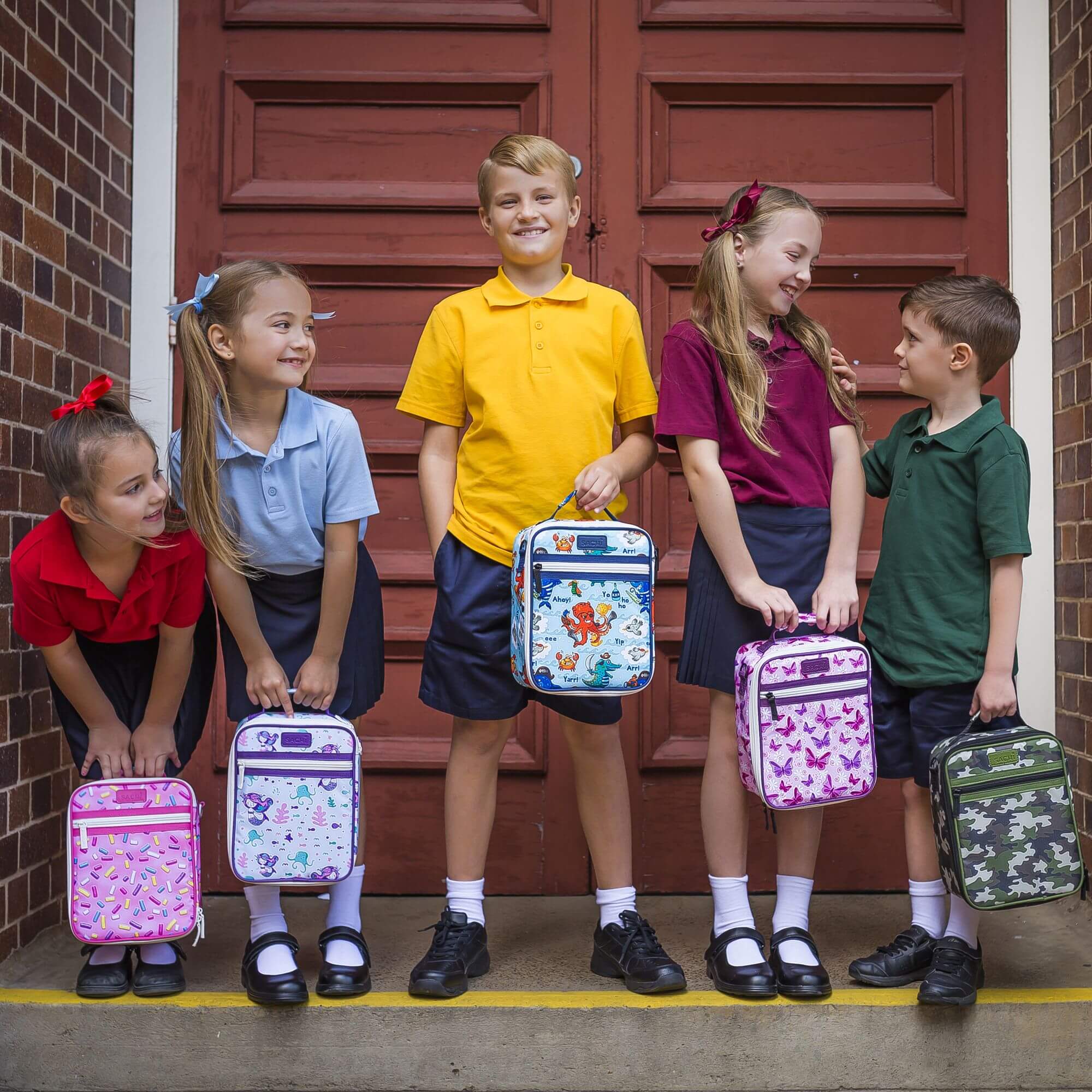 Children holding insulated lunch boxes with different designs
