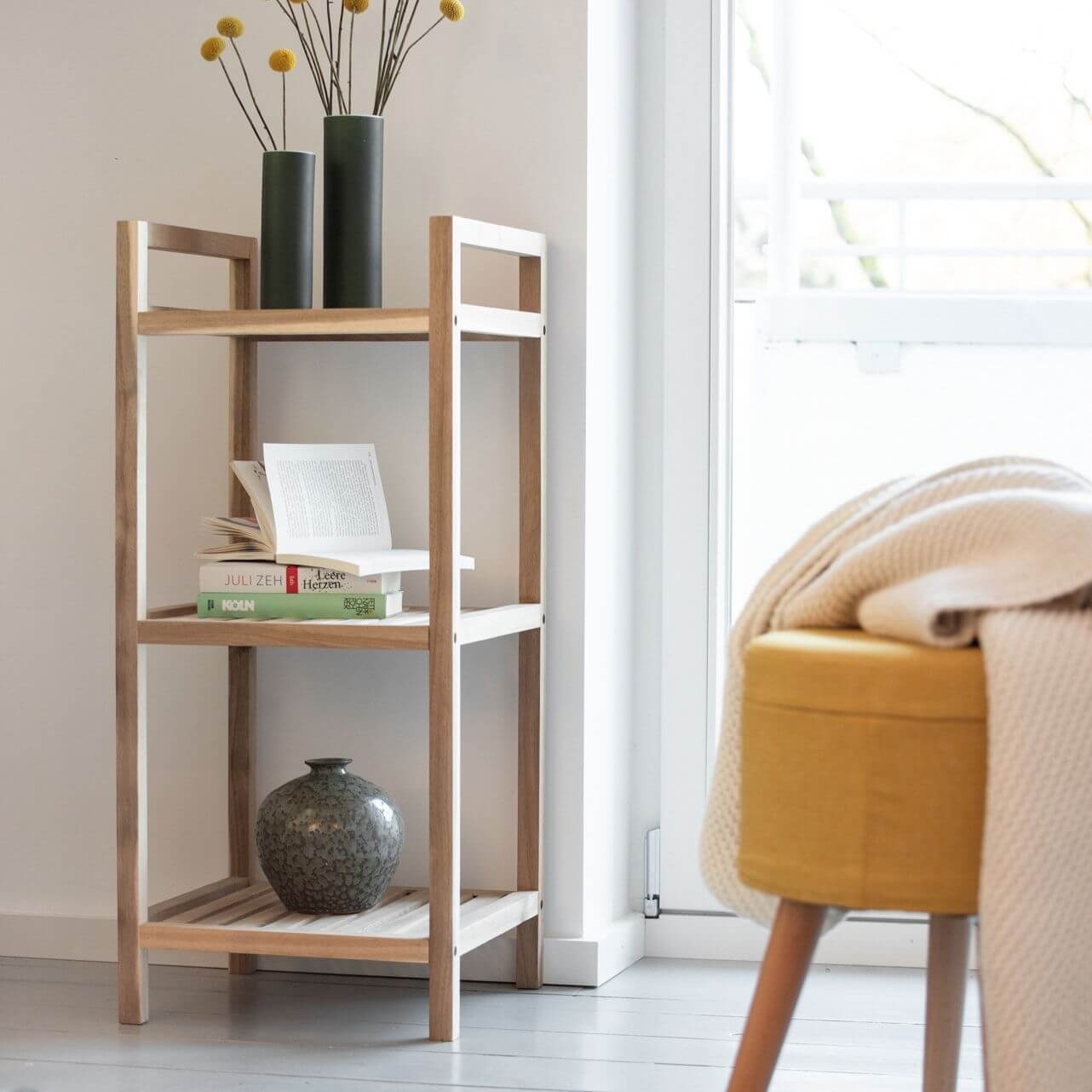 An FSC-certified wooden shelf unit standing next to a window