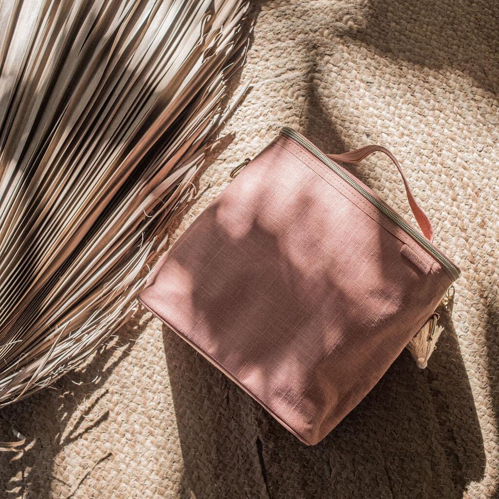 A clay SoYoung lunch bag on a natural material rug