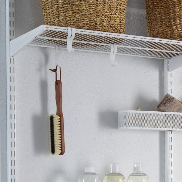 Three White Elfa Shelf Hooks storing cleaning brushes in the laundry