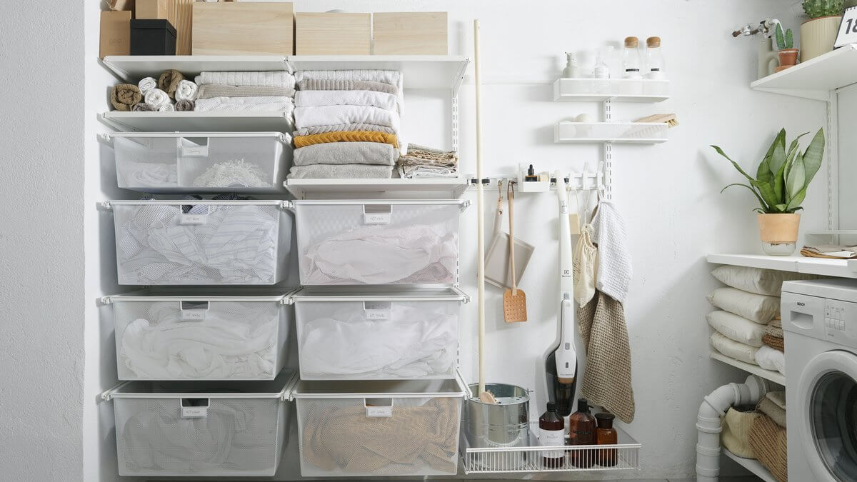 White Elfa Gliding Mesh Drawers installed in a laundry as wall-mounted clothes hampers
