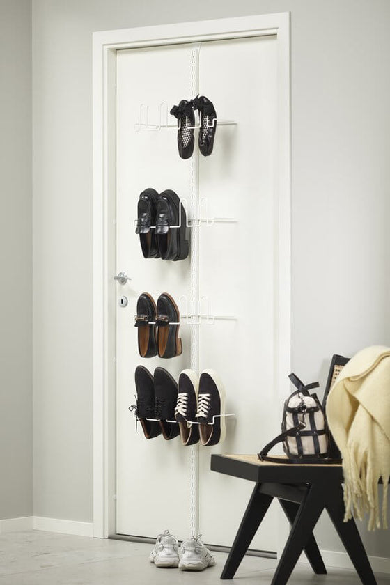 A White Elfa Utility Wall & Door system with Centre Shoe Racks, used as an over-door shoe rack