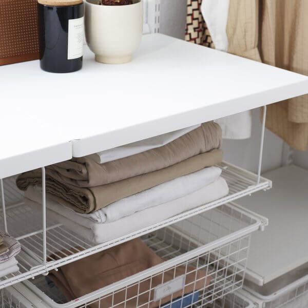 Two Elfa Wire Shelf Dividers installed on Wire Shelves to organise laundry