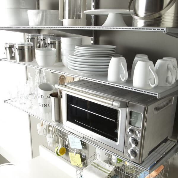 Transparent Elfa Shelf Liners installed on Platinum Elfa Wire Shelves for storing plates, cups, pantry canisters and appliances in a kitchen 