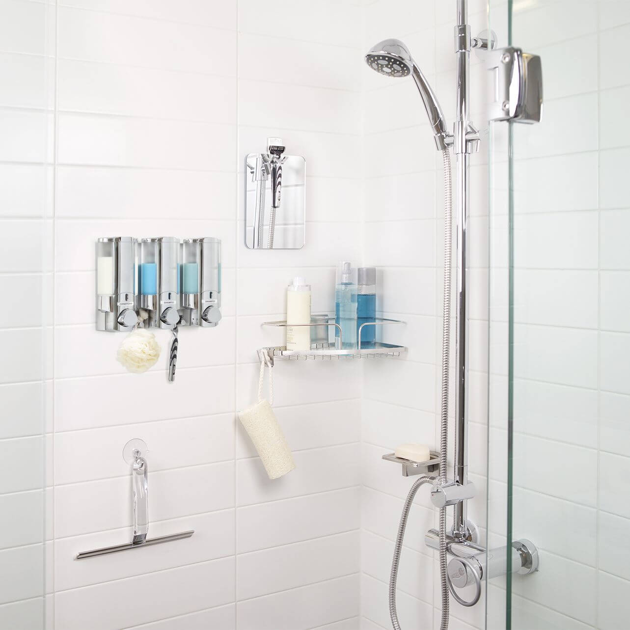 A white shower with stainless steel shower storage items