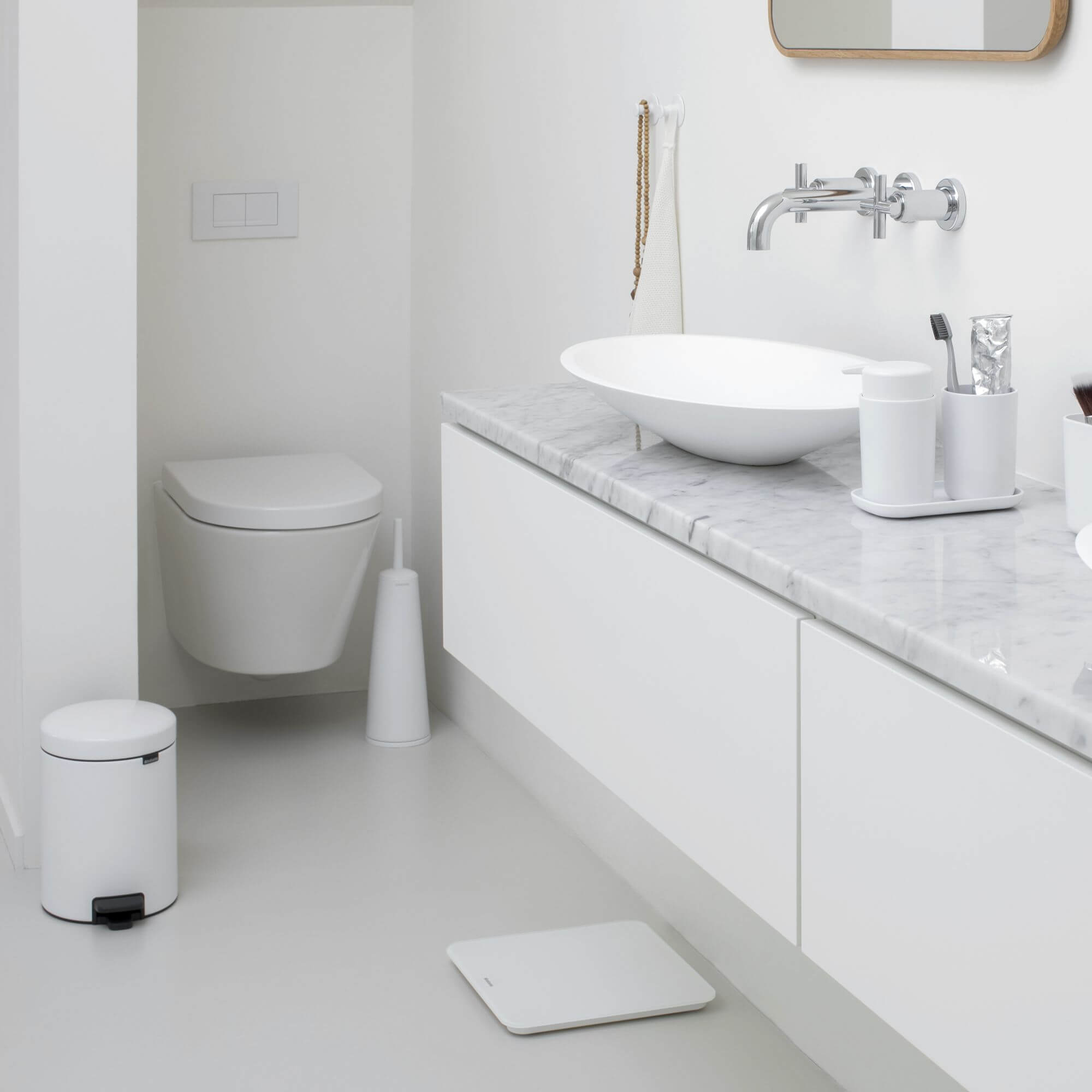 White bathroom accessories and storage solutions in a modern bathroom