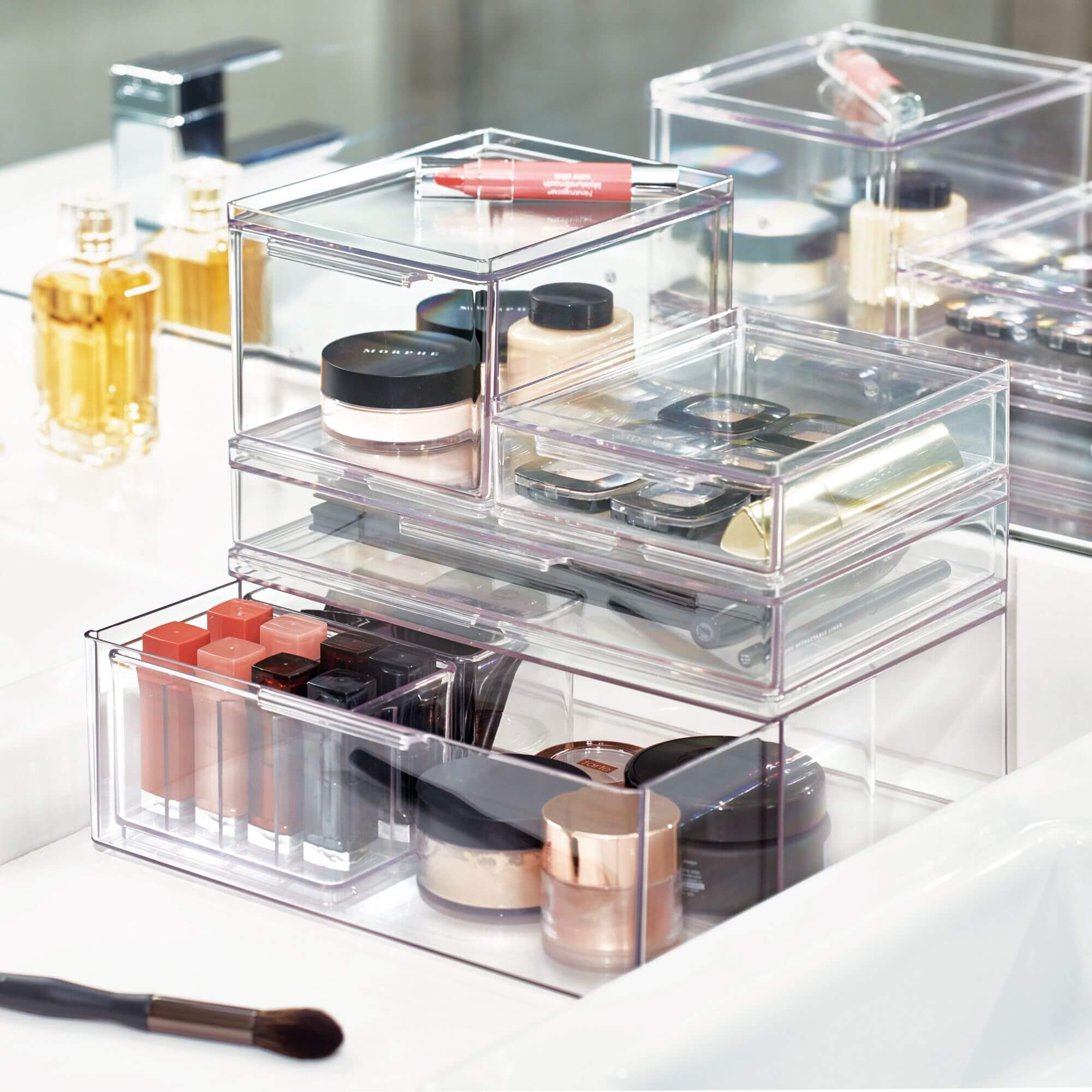 The Home Edit's range of clear makeup organisers on a bathroom vanity