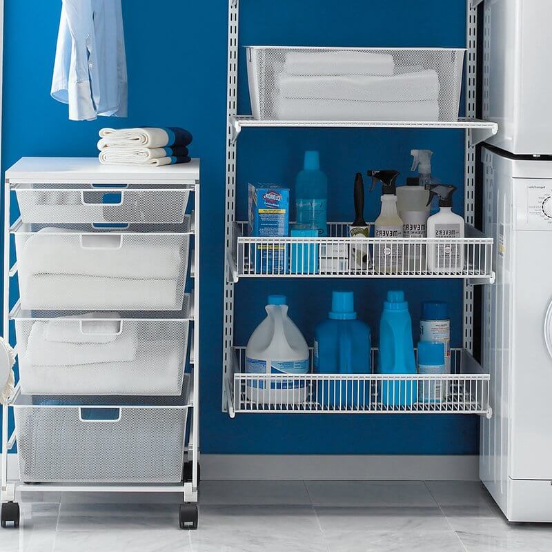 Linen and towels stored in a White Elfa Basics Freestanding Drawer Kit in a laundry room
