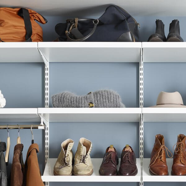 White Elfa Decor Shelves holding shoes, clothes and bags in a wardrobe