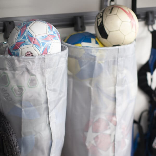 Soccer balls stored inside two Grey Elfa Mesh Storage Bags