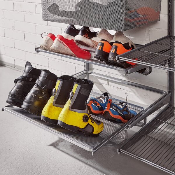Four pairs of shoes stored on a Platinum Elfa Gliding Mesh Shoe Shelf