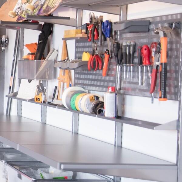 Screwdrivers and other tools stored on a Platinum Elfa Storing Board in a workshop