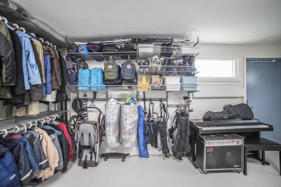 Coats, jackets and sports equipment stored in a Platinum Elfa garage system