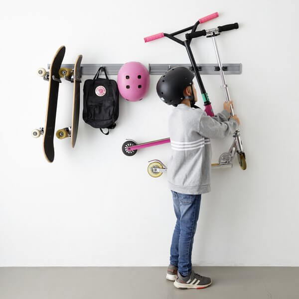 Skateboards, bags and scooters stored on a Platinum Elfa Storage Track