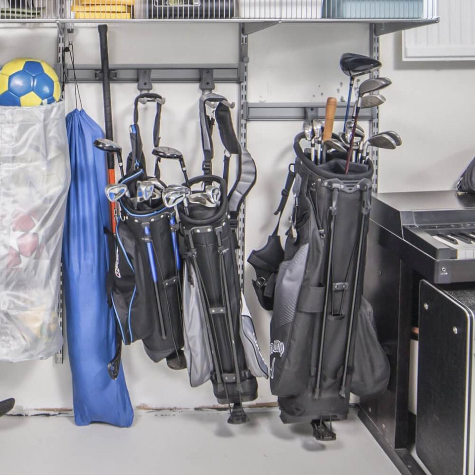 Three golf caddies and golf clubs stored on a Platinum Elfa Storage Track