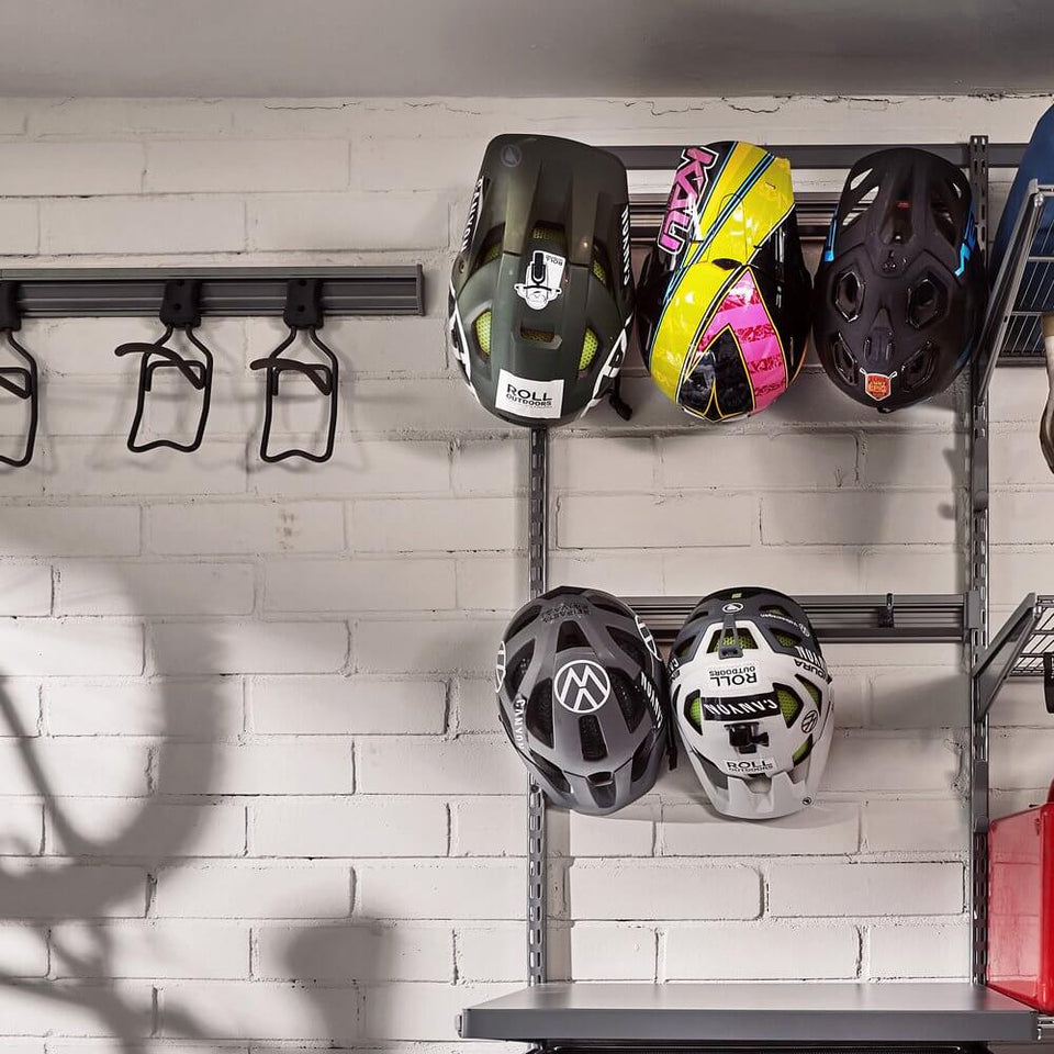 Bicycle helmets stored on a Platinum Elfa Storage Track above a work bench