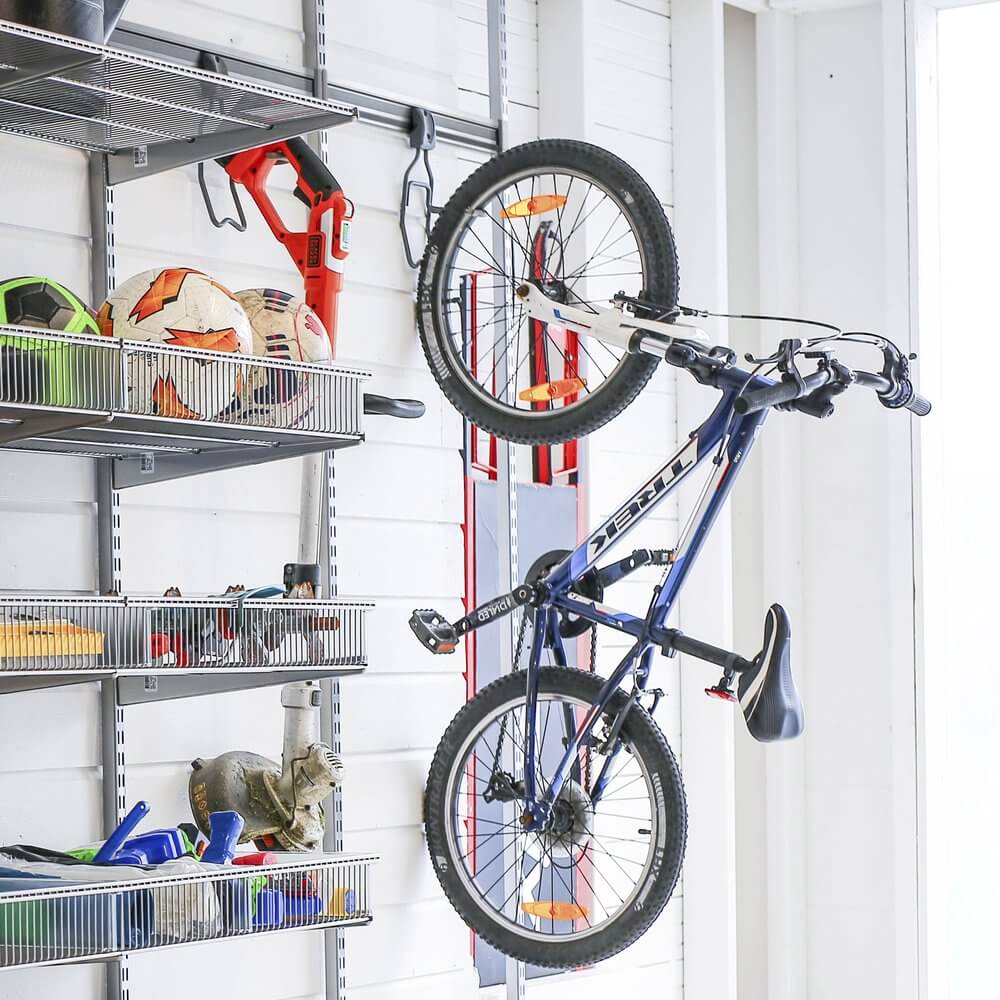 Platinum Elfa Wire Shelf Baskets storing garage equipment, with a bicycle wall-mounted on an Elfa Vertical Bike Rack