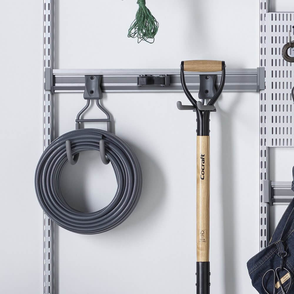 Shovels and hoses stored on a Platinum Elfa Storage Track
