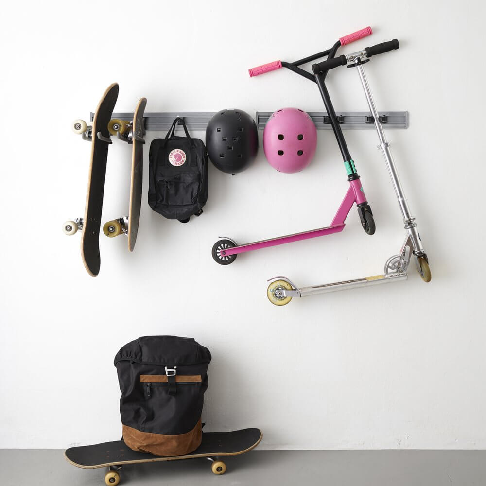 Skateboards, bags, helmets and scooters stored on a Platinum Elfa Storage Track