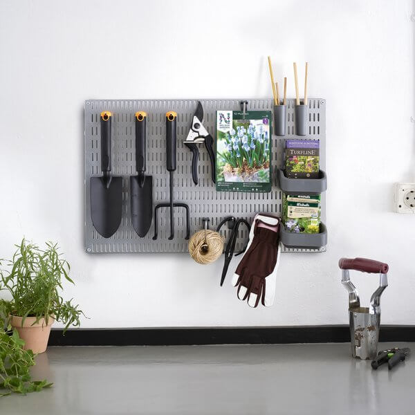 Small gardening tools and plant seeds stored on a Platinum Elfa Storing Board