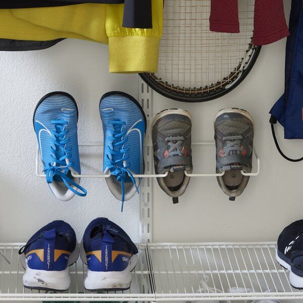 Two pairs of shoes hanging on an Elfa Centre Shoe Rack