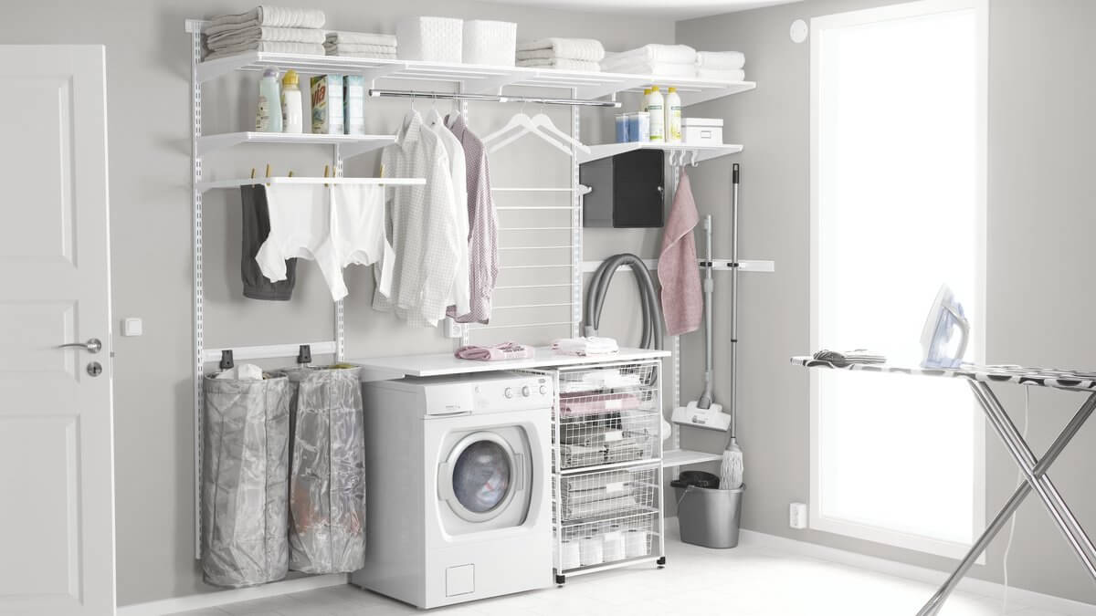 White Elfa shelving and a Freestanding Drawer Kit being used in a laundry to organise items and air-dry washing
