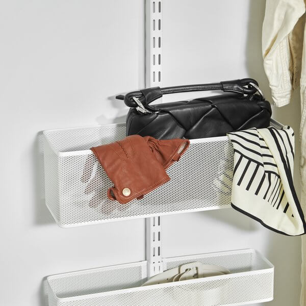 White Elfa Mesh Utility Basket stores purses, gloves, scarves and belts in the bedroom