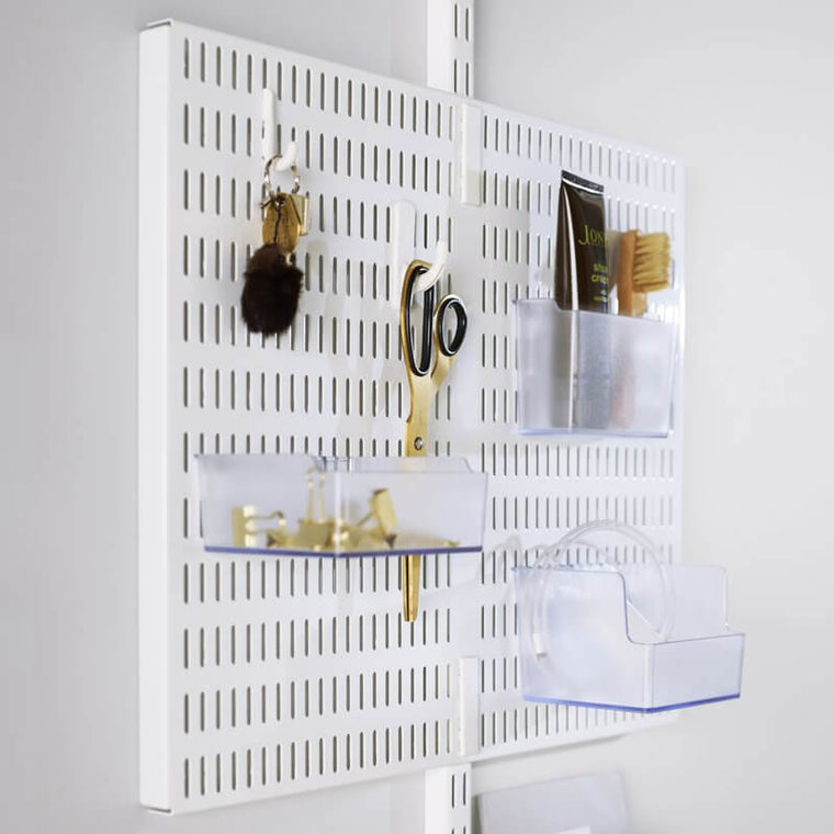 A White Elfa Centre Storing Board with storage trays and hooks for organising stationery