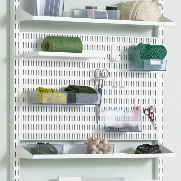 A White Elfa Storing Board organising scissors and sewing supplies