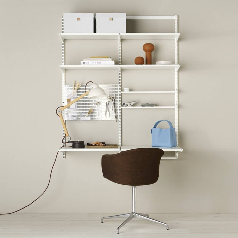 A modular Elfa office shelving system with adjustable melamine shelves and a White Storing Board