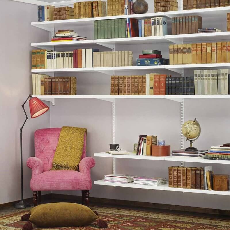 A White Elfa bookshelf with solid melamine shelving