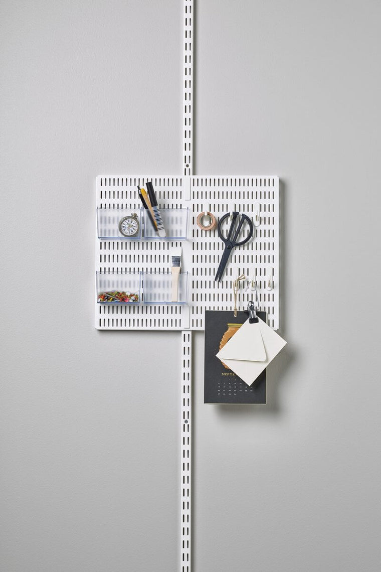 A White Elfa Utility Wall & Door system with a Centre Storing Board, used for wall-mounted stationery storage