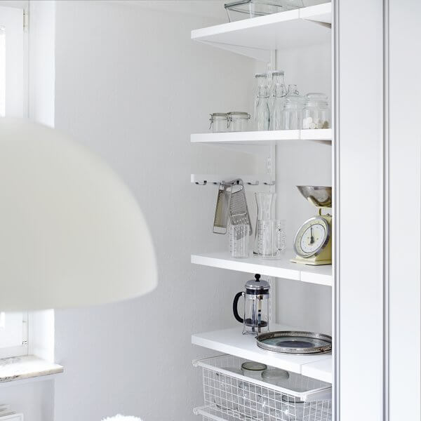 White timber Elfa shelves installed in a pantry, along with a Gliding Wire Drawer for storing glassware