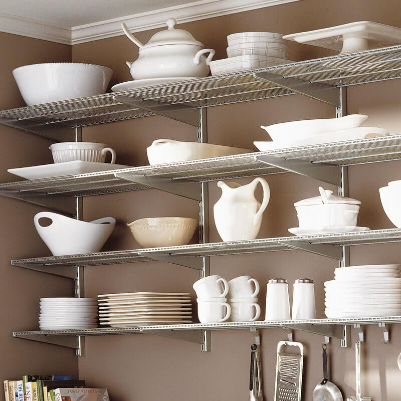 Platinum Elfa Wire Shelves used for storage of plates, bowls, mugs and serving trays in a kitchen