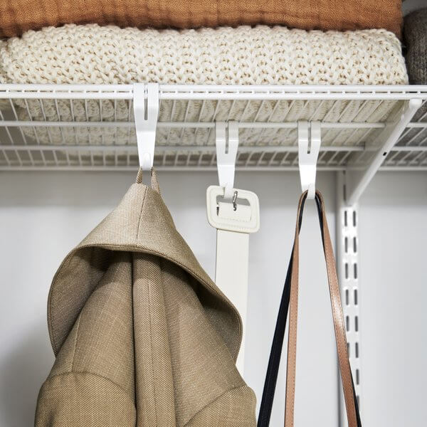 White Elfa Shelf Hooks clip onto Wire Shelves and hang belts, coats, bags and other wardrobe items