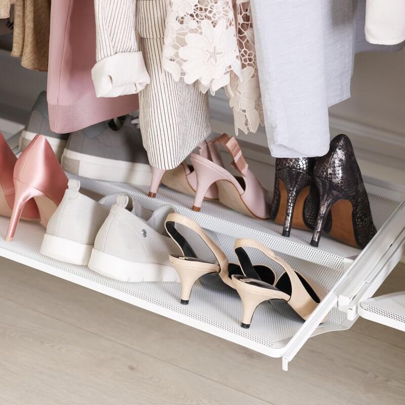 A White Elfa Gliding Shoe Shelf storing clothes in a wardrobe