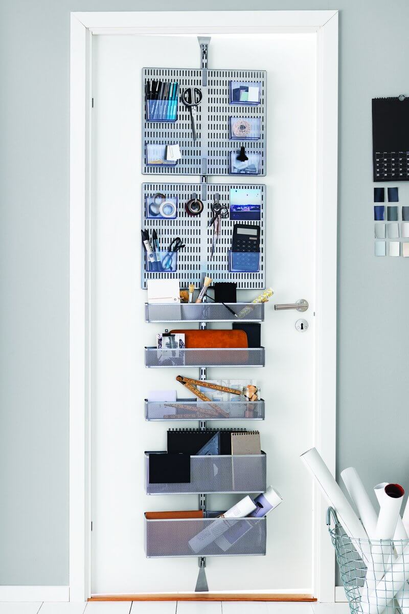 A Platinum Elfa Utility Wall & Door system with Mesh Utility Baskets and Centre Storing Boards, used for over-the-door storage of stationery, paper, books and office equipment