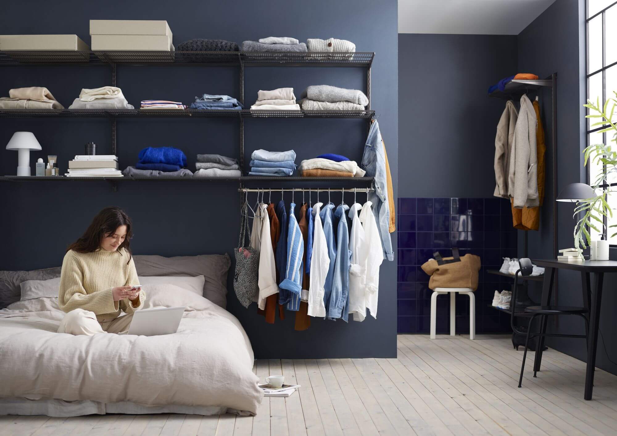 Elfa platinum wardrobe shelving in a blue bedroom