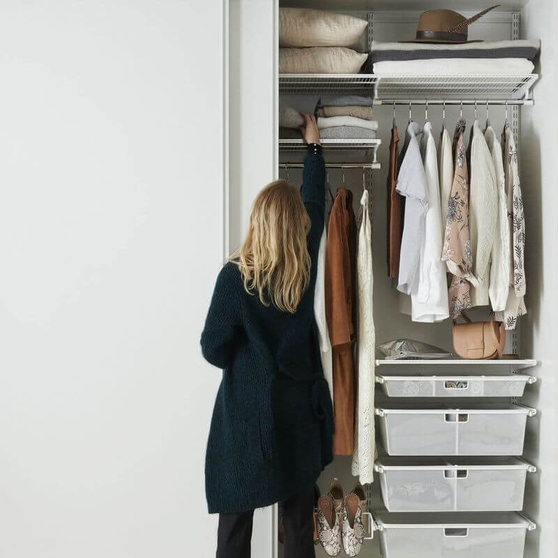 A White Elfa wardrobe with Gliding Mesh Drawers for storing clothes